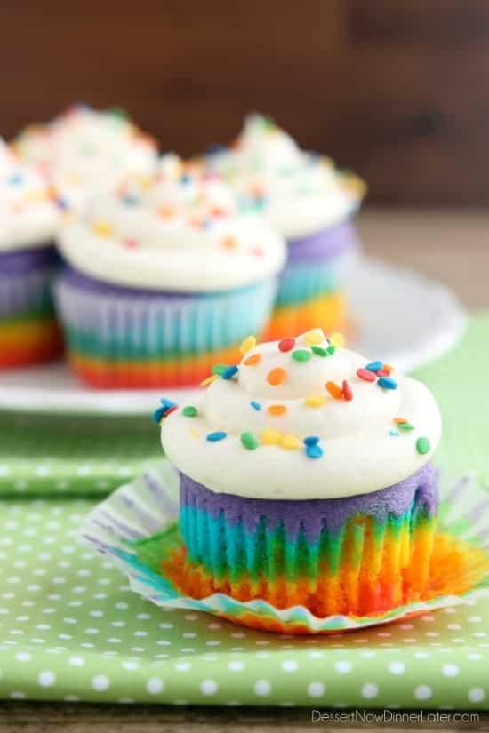 These Rainbow Cupcakes are made with a simple boxed white cake mix, colored, and layered to make a rainbow, with whipped cream cheese frosting on top! (Includes photo tutorial, and tips on baking cupcakes to perfection!)