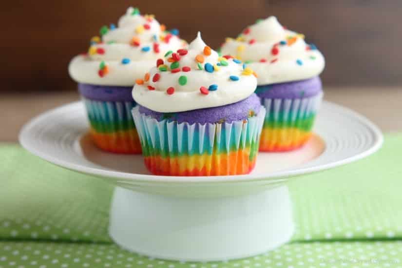 These Rainbow Cupcakes are made with a simple boxed white cake mix, colored, and layered to make a rainbow, with whipped cream cheese frosting on top! (Includes photo tutorial, and tips on baking cupcakes to perfection!)