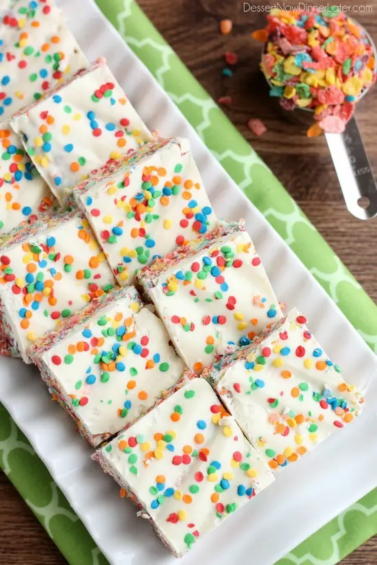 Fruity Pebbles, marshmallows, white chocolate, and confetti sprinkles, come together to make these Rainbow Krispie Treats! An easy St. Patrick's Day dessert!