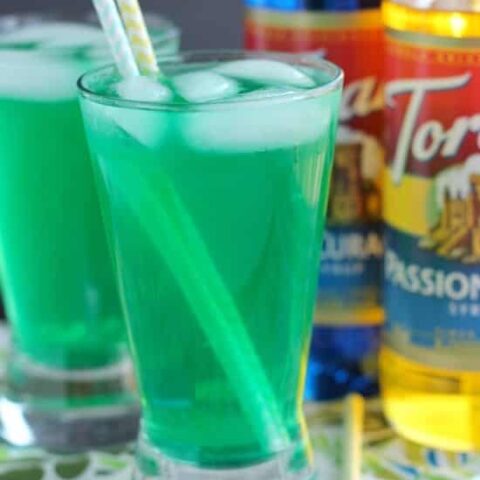 Xanadew - this FIIZ soda shop copycat drink recipe uses blue curacao and passion fruit syrups mixed into Mountain Dew for a fun green tropical mocktail!