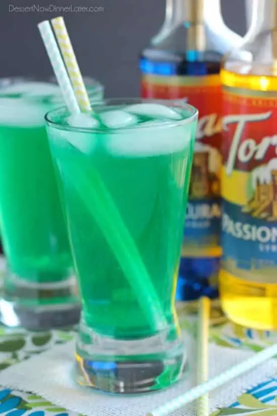 Xanadew - this FIIZ soda shop copycat drink recipe uses blue curacao and passion fruit syrups mixed into Mountain Dew for a fun green tropical mocktail!