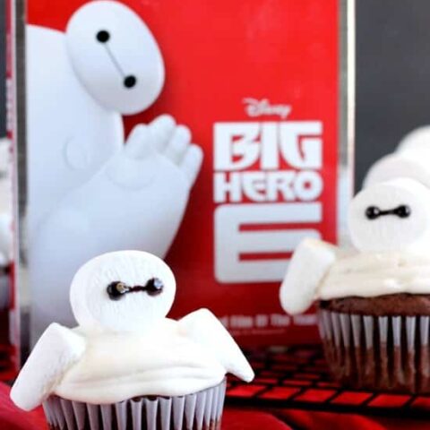 Big Hero 6 comes to life at home with these Baymax Cupcakes topped with marshmallow frosting and large marshmallows. {Step-by-Step Tutorial}