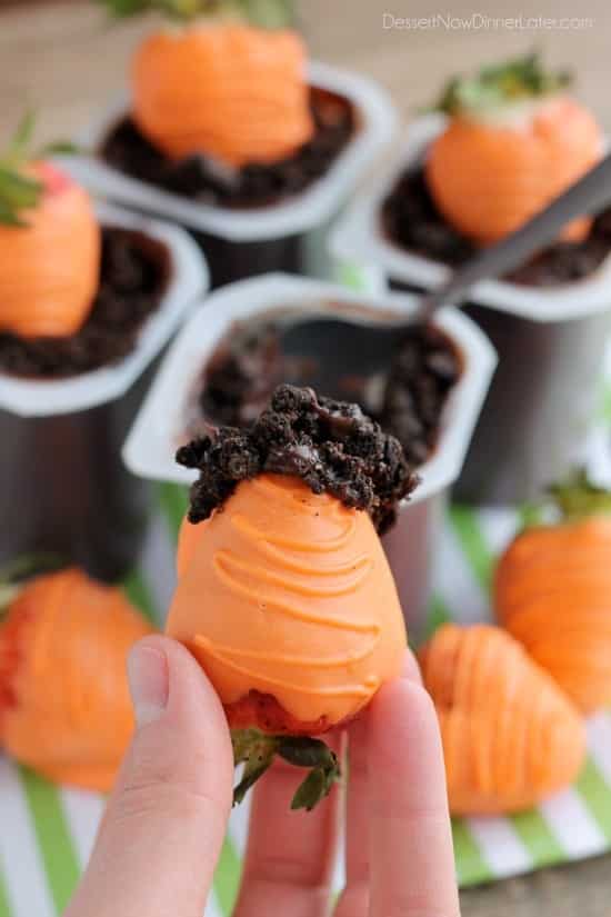 Carrot Easter Pudding Cups - These fun pudding cups are perfect for Spring and Easter with an orange candy dipped strawberry "carrot" in crushed Oreo and chocolate pudding "dirt."
