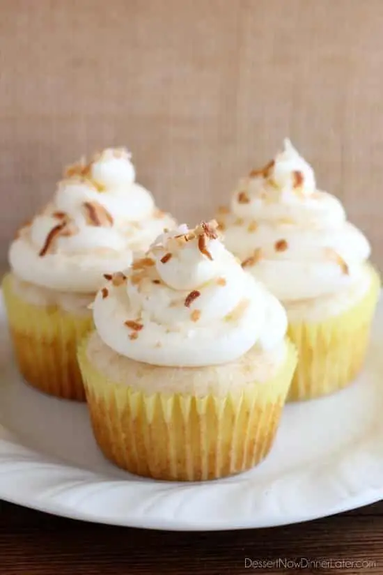 These Pina Colada Cupcakes have crushed pineapple in the cake, and coconut & rum extracts in the frosting, for a frozen drink inspired tropical dessert!