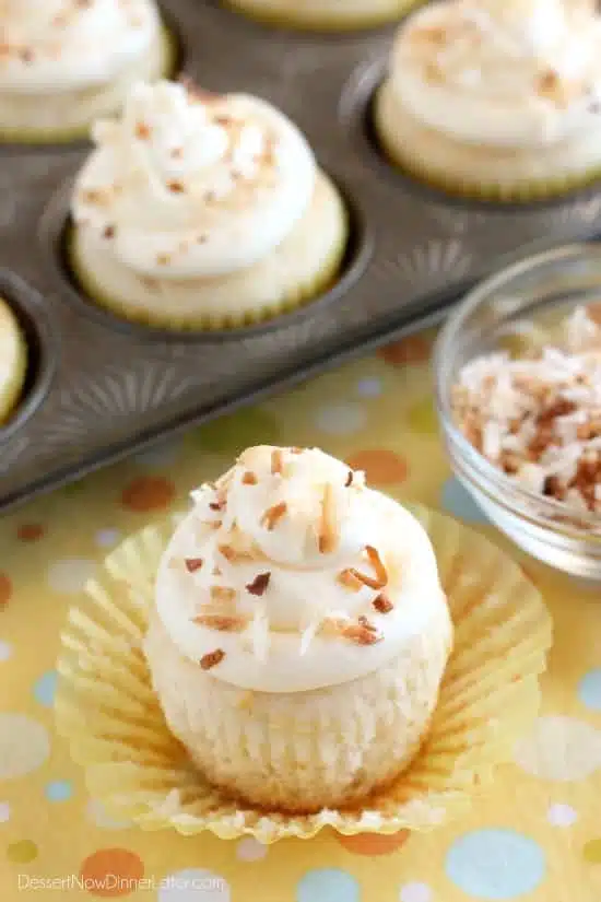 These Pina Colada Cupcakes have crushed pineapple in the cake, and coconut & rum extracts in the frosting, for a frozen drink inspired tropical dessert!