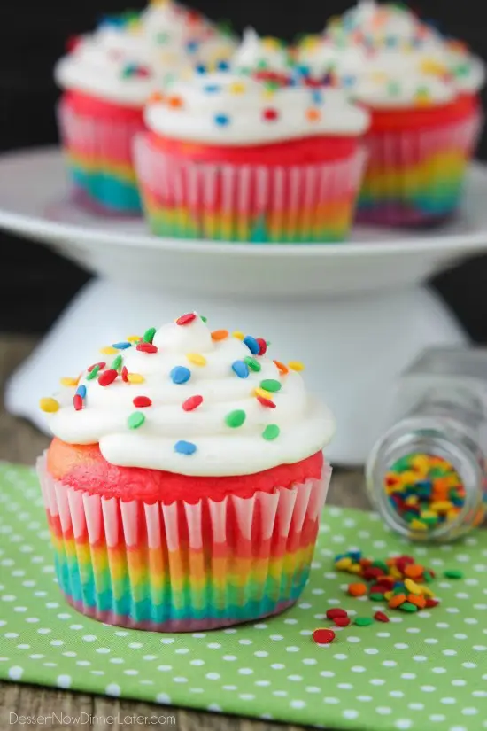 These Rainbow Cupcakes are made with a simple boxed white cake mix, colored, and layered to make a rainbow, with whipped cream cheese frosting on top! (Includes photo tutorial, and tips on baking cupcakes to perfection!)