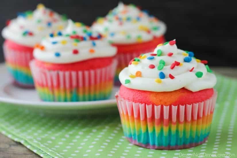 These Rainbow Cupcakes are made with a simple boxed white cake mix, colored, and layered to make a rainbow, with whipped cream cheese frosting on top! (Includes photo tutorial, and tips on baking cupcakes to perfection!)