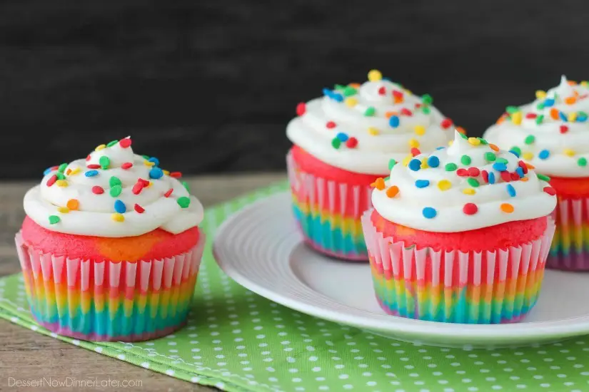 These Rainbow Cupcakes are made with a simple boxed white cake mix, colored, and layered to make a rainbow, with whipped cream cheese frosting on top! (Includes photo tutorial, and tips on baking cupcakes to perfection!)
