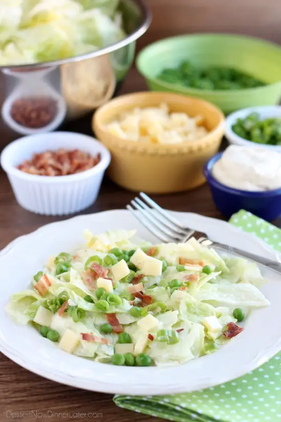 Sarah's Salad from Utah's Lion House restaurant uses crisp iceberg lettuce, peas, bacon, green onions, and swiss cheese tossed in a simple, sweet dressing.