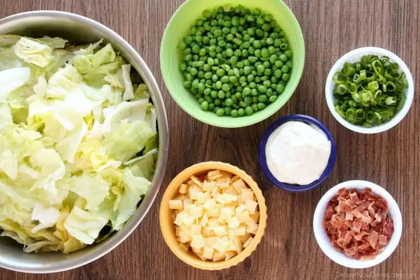 Sarah's Salad from Utah's Lion House restaurant uses crisp iceberg lettuce, peas, bacon, green onions, and swiss cheese tossed in a simple, sweet dressing.