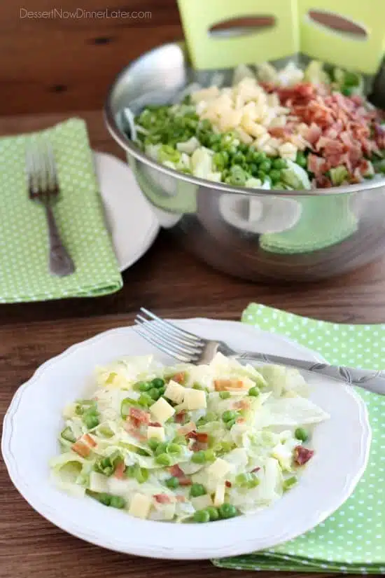 Sarah's Salad from Utah's Lion House restaurant uses crisp iceberg lettuce, peas, bacon, green onions, and swiss cheese tossed in a simple, sweet dressing.