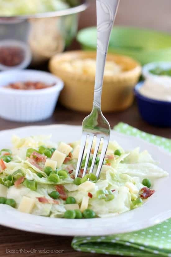 Sarah's Salad from Utah's Lion House restaurant uses crisp iceberg lettuce, peas, bacon, green onions, and swiss cheese tossed in a simple, sweet dressing.