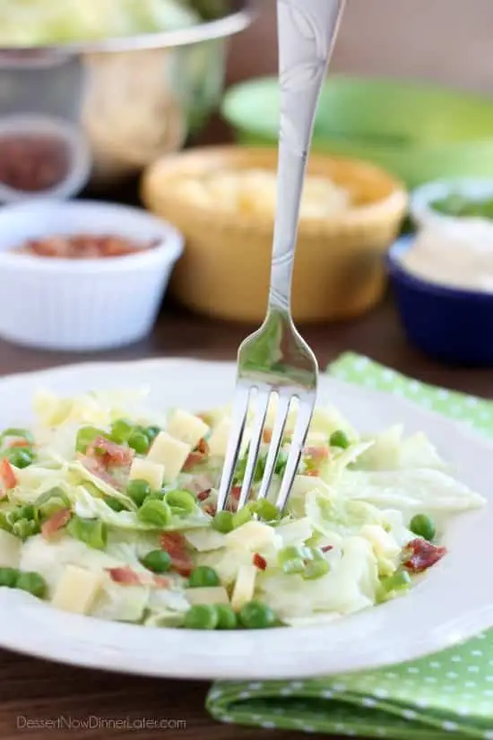 Sarah's Salad from Utah's Lion House restaurant uses crisp iceberg lettuce, peas, bacon, green onions, and swiss cheese tossed in a simple, sweet dressing.