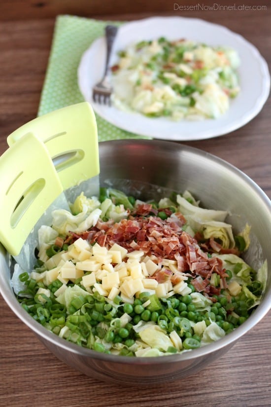 Sarah's Salad from Utah's Lion House restaurant uses crisp iceberg lettuce, peas, bacon, green onions, and swiss cheese tossed in a simple, sweet dressing.