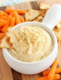 This Easy Garlic Hummus blends up in less than 1 minute for a smooth and creamy homemade hummus that goes perfectly with vegetables and crackers!