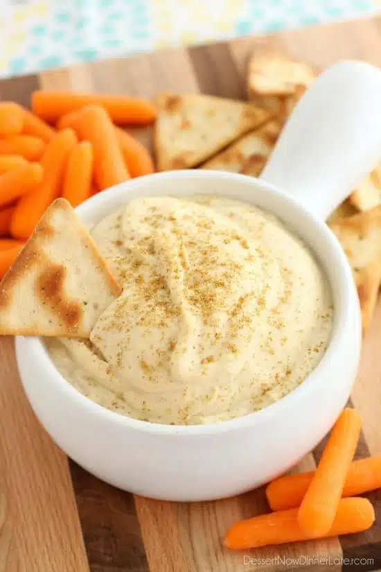 This Easy Garlic Hummus blends up in less than 1 minute for a smooth and creamy homemade hummus that goes perfectly with vegetables and crackers!