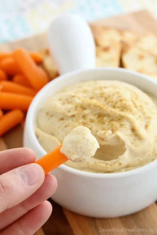 This Easy Garlic Hummus blends up in less than 1 minute for a smooth and creamy homemade hummus that goes perfectly with vegetables and crackers!