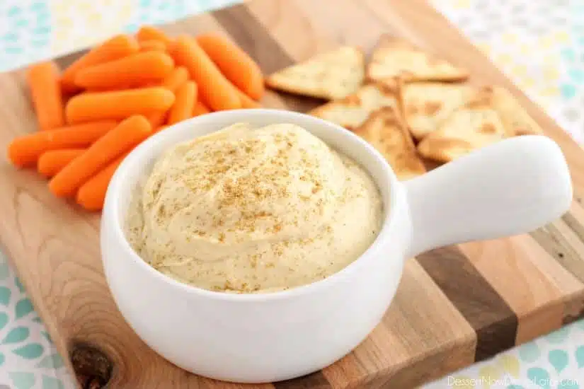 This Easy Garlic Hummus blends up in less than 1 minute for a smooth and creamy homemade hummus that goes perfectly with vegetables and crackers!