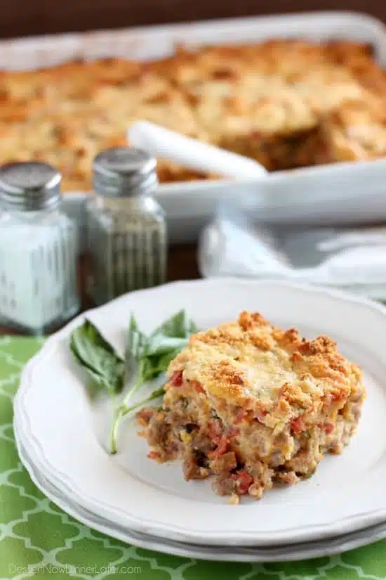 Savory Breakfast Bread Pudding has sausage, tomatoes, eggs, and herbs all in a cheesy bread pudding.