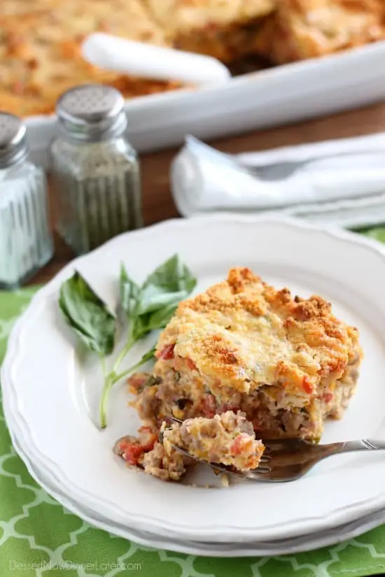 Savory Breakfast Bread Pudding has sausage, tomatoes, eggs, and herbs all in a cheesy bread pudding.