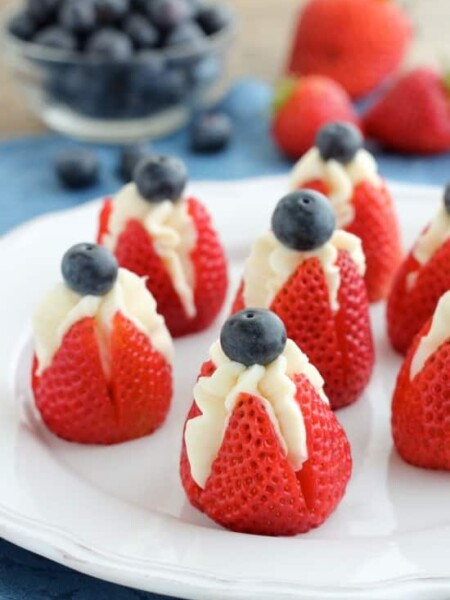 Try these easy red, white, and blue Cheesecake Stuffed Strawberries for a healthier patriotic dessert!