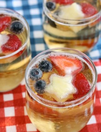 This Patriotic Punch is a fizzy drink made easy with only two ingredients and decorated with fruit for a red, white, and blue, party punch the whole family can enjoy!