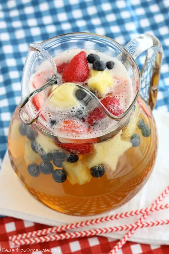 This Patriotic Punch is a fizzy drink made easy with only two ingredients and decorated with fruit for a red, white, and blue, party punch the whole family can enjoy!