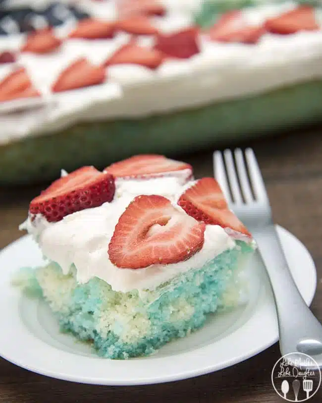 Red strawberries, white cake, and blue jello, come together to create this simple and delicious patriotic Red, White, and Blue Jello Poke Cake perfect for the 4th of July! 