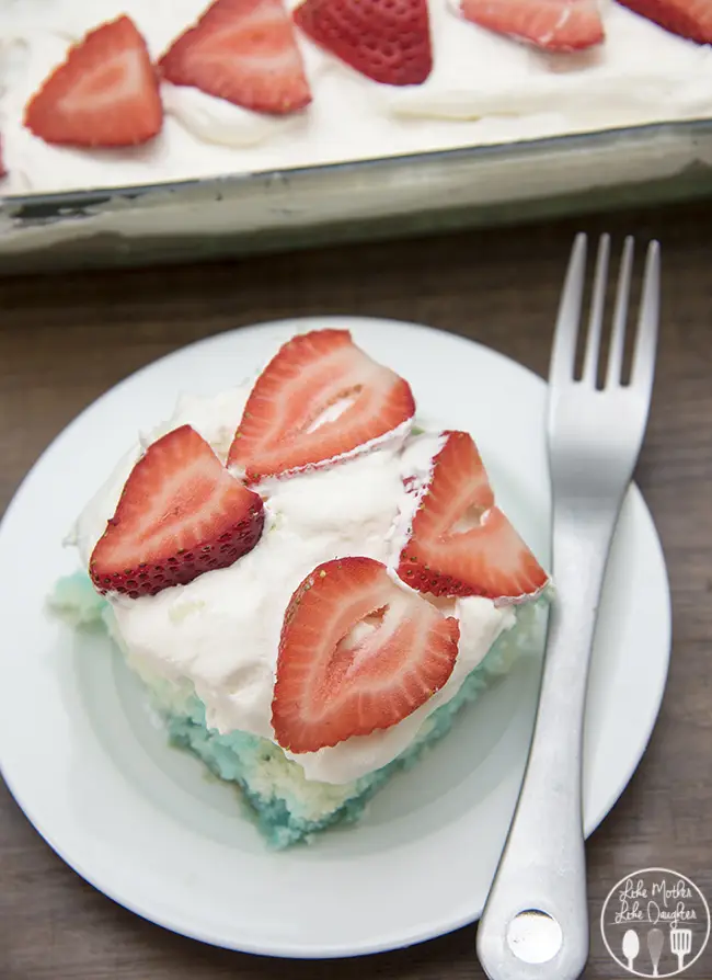 Red strawberries, white cake, and blue jello, come together to create this simple and delicious patriotic Red, White, and Blue Jello Poke Cake perfect for the 4th of July! 
