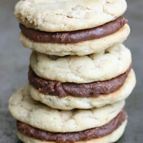 Chewy Peanut Butter Cookies are sandwiched between a simple Fudge Frosting to create an ultimate peanut butter chocolate cookie worth devouring!