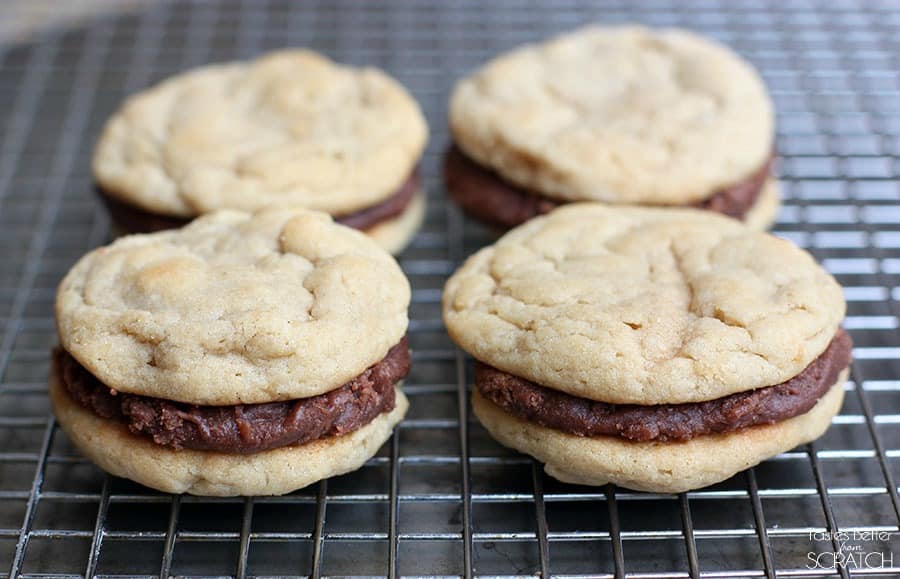 Chewy Peanut Butter Cookies are sandwiched between a simple Fudge Frosting to create an ultimate peanut butter chocolate cookie worth devouring!