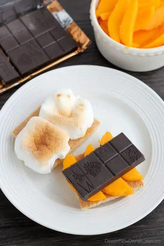 Mango S'mores - fresh mango slices, toasty marshmallows, and Brookside's Mango Coconut Crisp Chocolate Bar sandwiched between honey graham crackers.