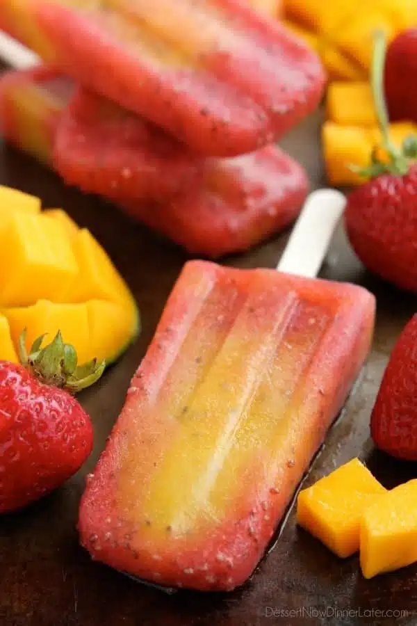 Beat the summer heat with these Strawberry Mango Chia Popsicles! Fresh fruit, chia seeds, and coconut water is all you need to whip up these hydrating pops.