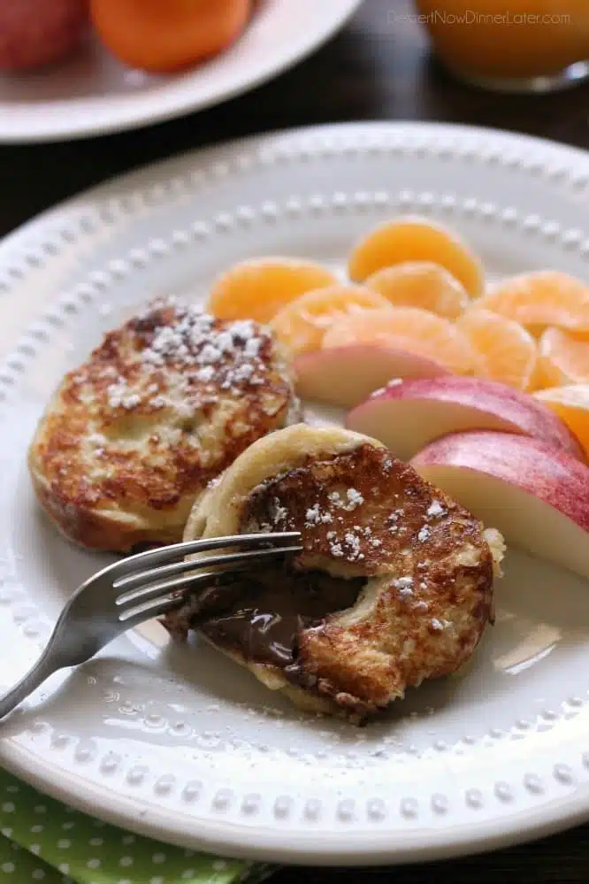 This Chocolate Stuffed French Toast is dipped in a sweet & buttery batter, then grilled until crisp on the outside and melty in the center. A perfect breakfast for the holidays or any time of year!