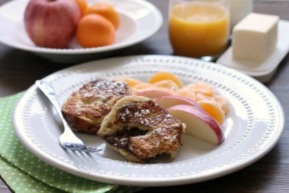 This Chocolate Stuffed French Toast is dipped in a sweet & buttery batter, then grilled until crisp on the outside and melty in the center. A perfect breakfast for the holidays or any time of year!