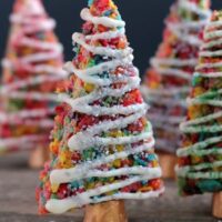 Fruity Pebbles cereal lights up these festive Krispie Treat Christmas Trees that are easy and fun to make for the holidays!
