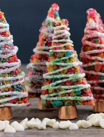 Fruity Pebbles cereal lights up these festive Krispie Treat Christmas Trees that are easy and fun to make for the holidays!