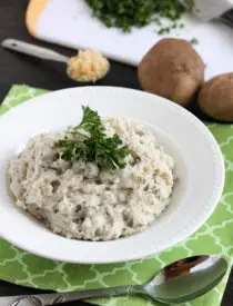 These Slow Cooker Mashed Potatoes are packed with flavor thanks to garlic and herbs, and making them in the slow cooker is the best solution for your Thanksgiving or Christmas dinner!