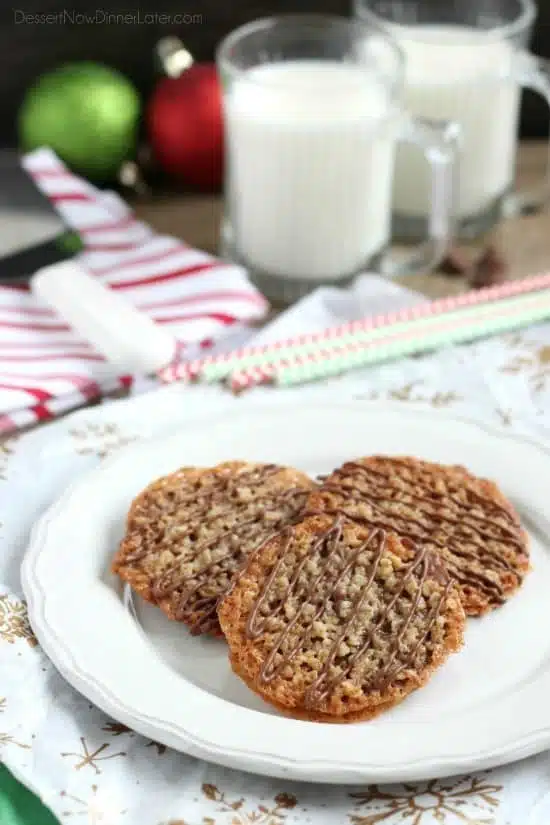 Thin, crisp, buttery cookies are sandwiched between melted milk chocolate with an extra chocolate drizzle on top. They taste like toffee and they look like lace. These Florentine Cookies are a holiday favorite!