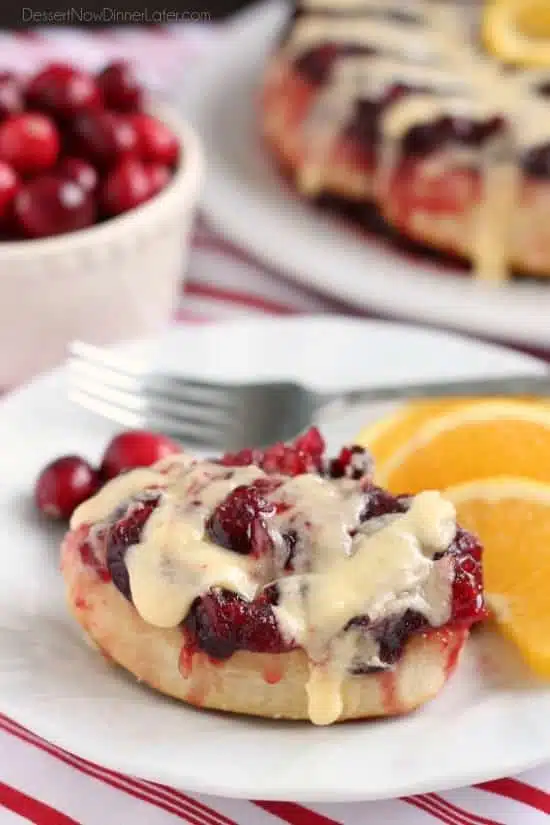 Frozen orange rolls are baked atop fresh cranberry sauce, inverted onto a dish, and drizzled with a delicious orange cream cheese glaze for a Christmas breakfast worth sharing with family and friends.