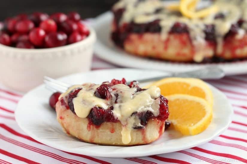 Frozen orange rolls are baked atop fresh cranberry sauce, inverted onto a dish, and drizzled with a delicious orange cream cheese glaze for a Christmas breakfast worth sharing with family and friends.