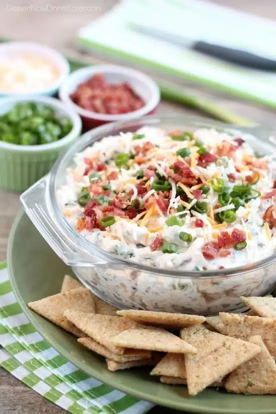 A loaded baked potato inspired this chip dip full of bacon, cheese, green onions, and ranch dressing mix. A delicious party dip or game day appetizer.