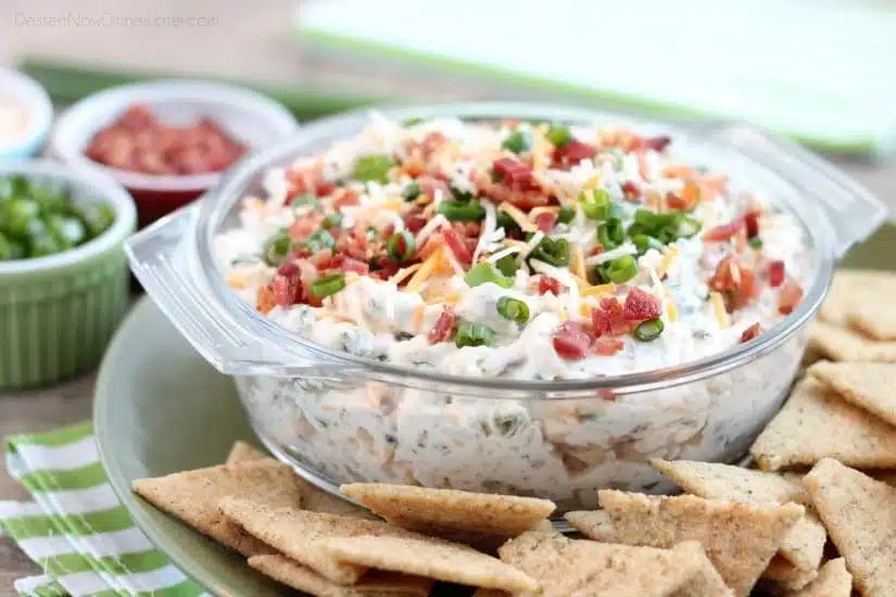 A loaded baked potato inspired this chip dip full of bacon, cheese, green onions, and ranch dressing mix. A delicious party dip or game day appetizer.