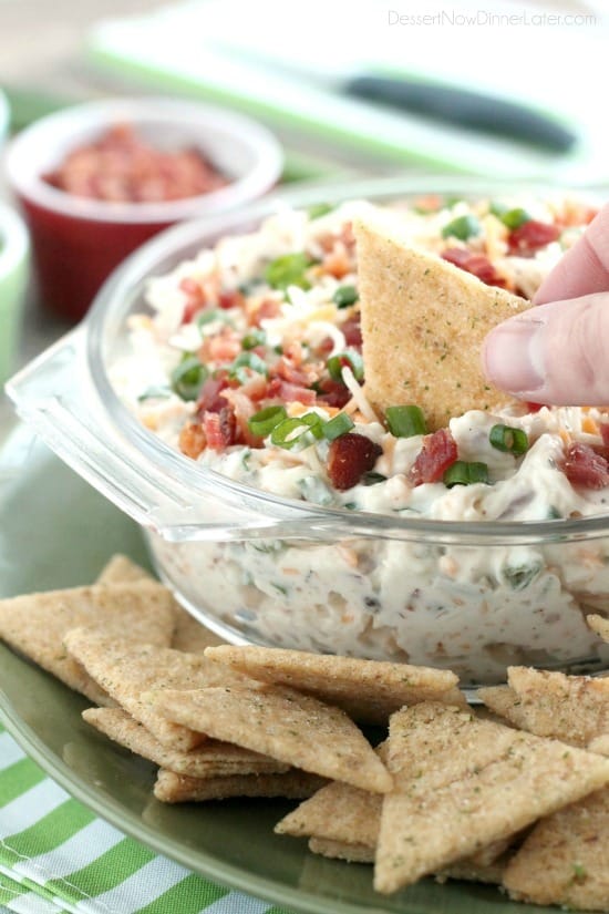 A loaded baked potato inspired this chip dip full of bacon, cheese, green onions, and ranch dressing mix. A delicious party dip or game day appetizer.