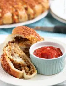 This Sausage Stromboli is a delicious hot sandwich that feeds a crowd! Make it for dinner or as an appetizer served with marinara for the big football game!