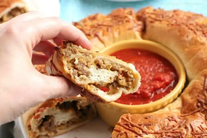 This Sausage Stromboli is a delicious hot sandwich that feeds a crowd! Make it for dinner or as an appetizer served with marinara for the big football game!