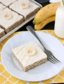 This is the BEST banana cake topped with the BEST cream cheese frosting! Perfect for picnics and potlucks, this banana sheet cake is a crowd pleaser! Everyone asks for the recipe!