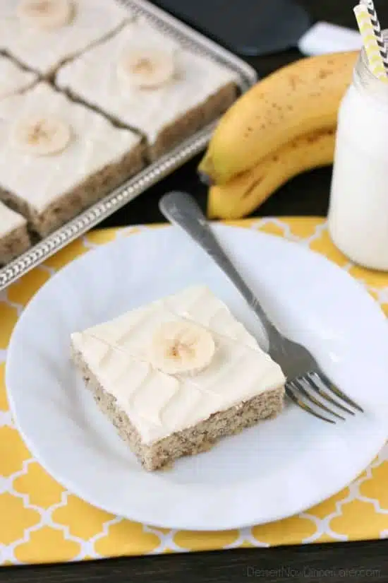 This is the BEST banana cake topped with the BEST cream cheese frosting! Perfect for picnics and potlucks, this banana sheet cake is a crowd pleaser! Everyone asks for the recipe!