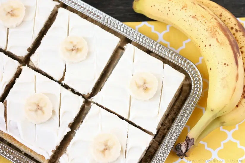 This is the BEST banana cake topped with the BEST cream cheese frosting! Perfect for picnics and potlucks, this banana sheet cake is a crowd pleaser! Everyone asks for the recipe!