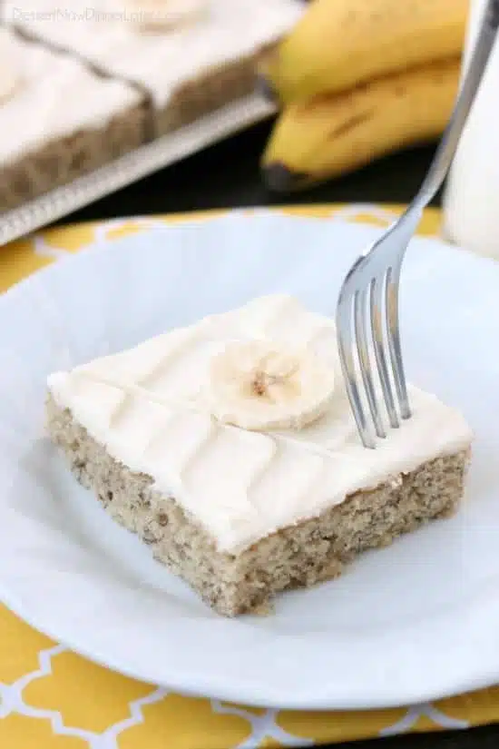 This is the BEST banana cake topped with the BEST cream cheese frosting! Perfect for picnics and potlucks, this banana sheet cake is a crowd pleaser! Everyone asks for the recipe!